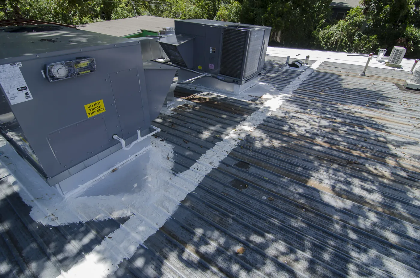 Austin Commercial No Slope Metal Roof Liquid Sealed Seams AC Units Finished View Freetail Roofing
