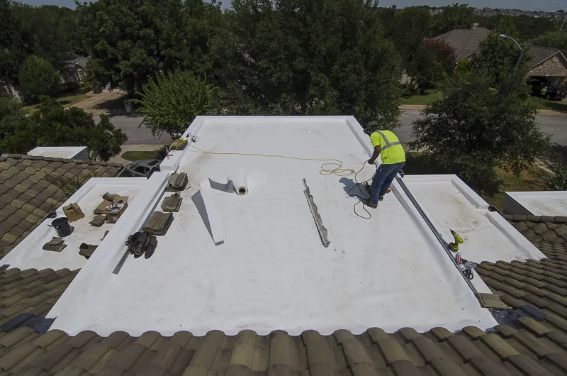 Lake Travis TPO roofing upgrade crew working on flat areas Freetail Roofing