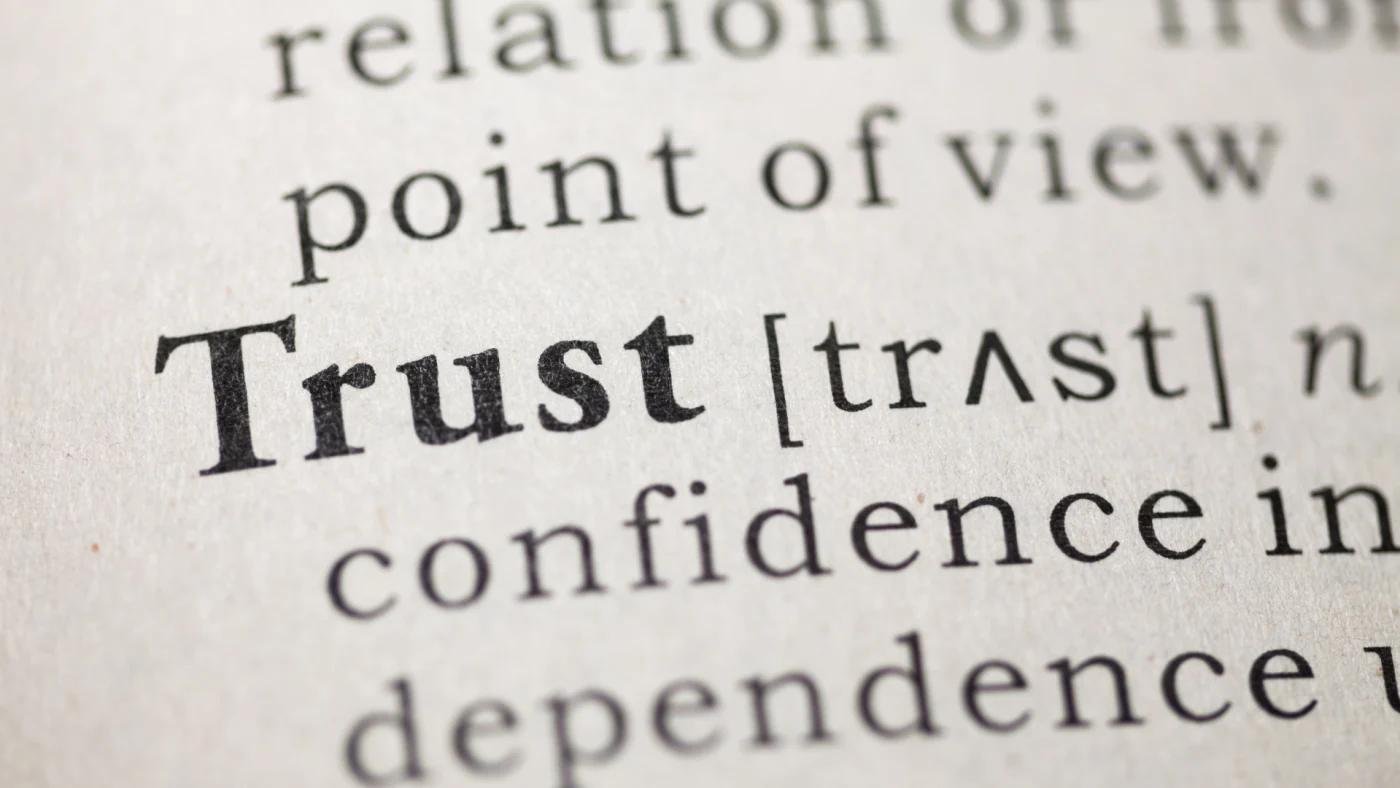 The word trust shown in a book.