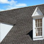Gray asphalt shingle roof with two white dormer windows in Burnet, TX | Freetail Roofing