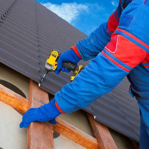 Worker Installing A Metal Roofs