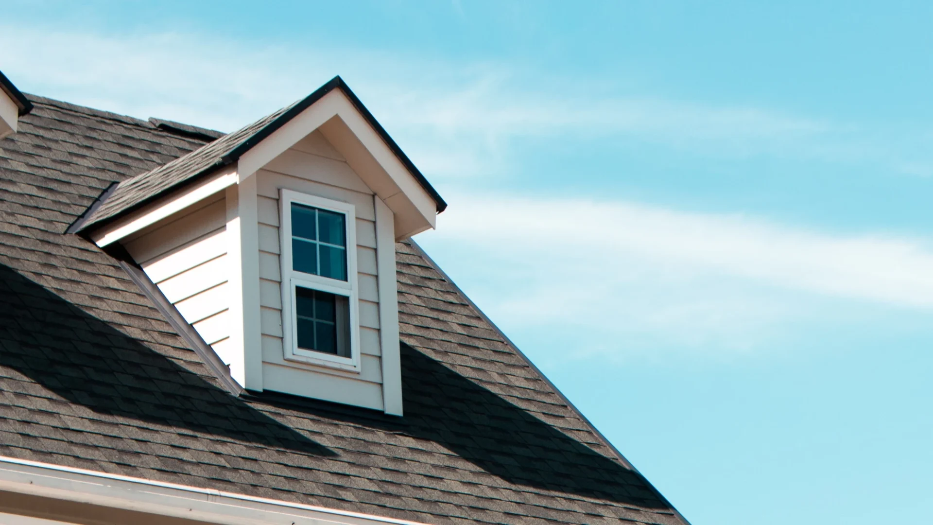 Best Roofing Services Volente Freetail Roofing Top corner of asphalt shingle roof with dormer window