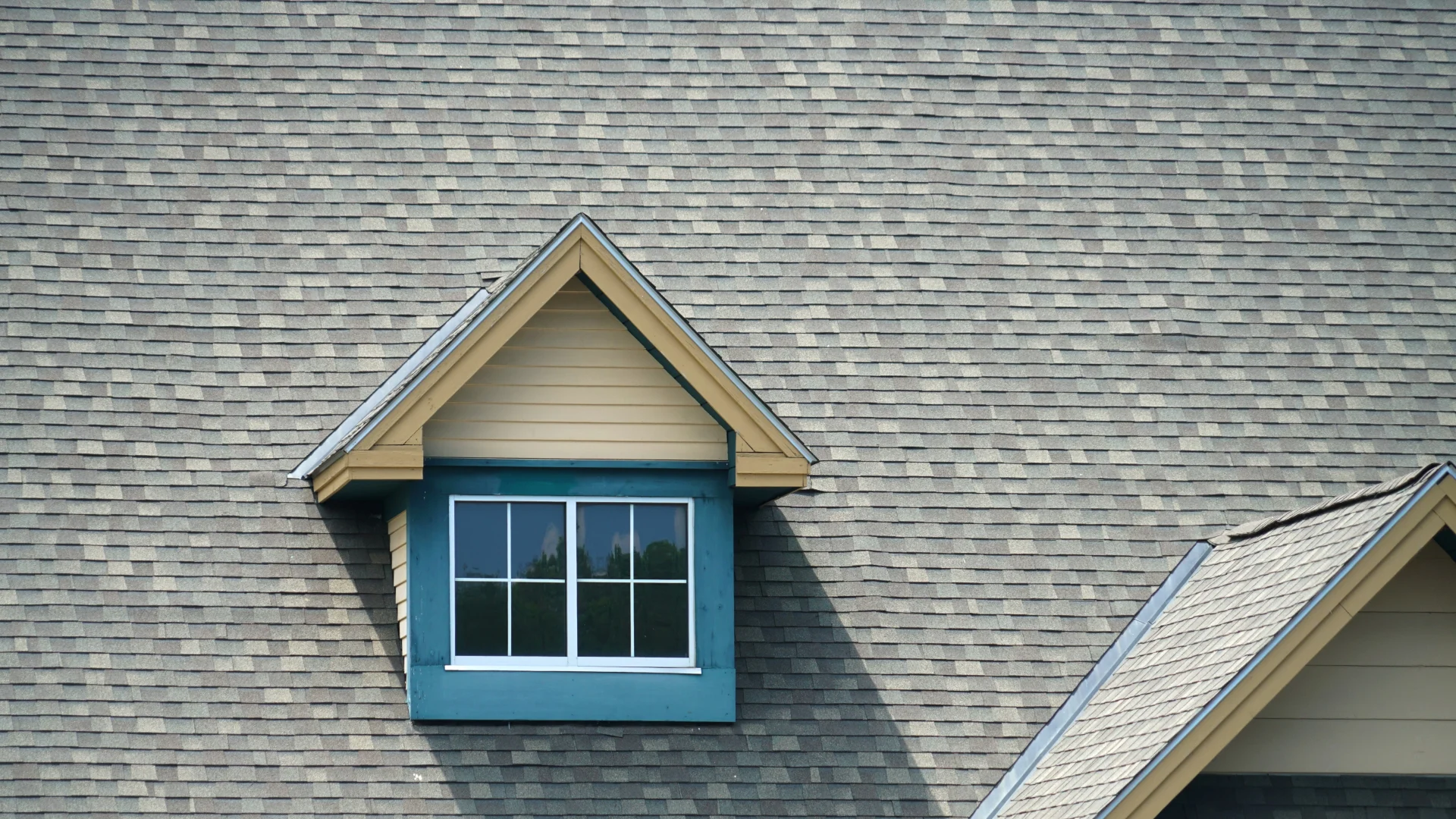 Large asphalt shingle roof with small roof window
