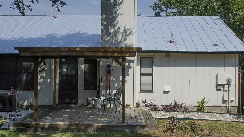 Texas home with seamless white siding and light blue seamless standing metal roof
