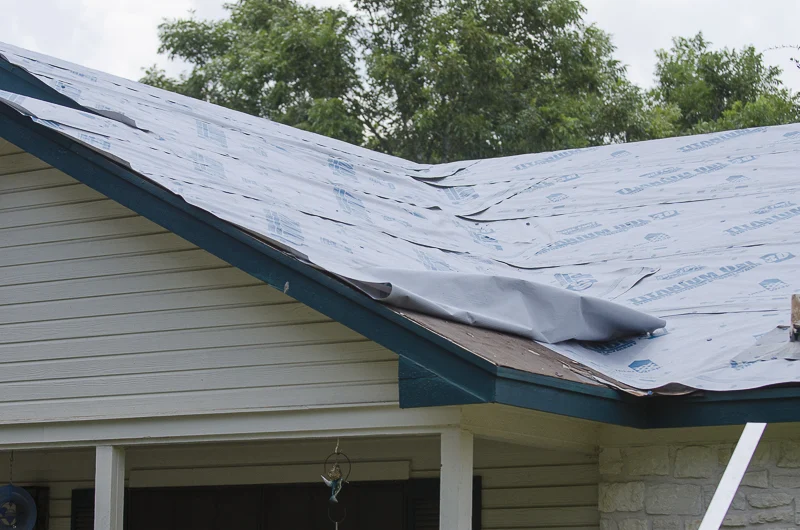 Underlayment being placed on roof before residential roof replacement
