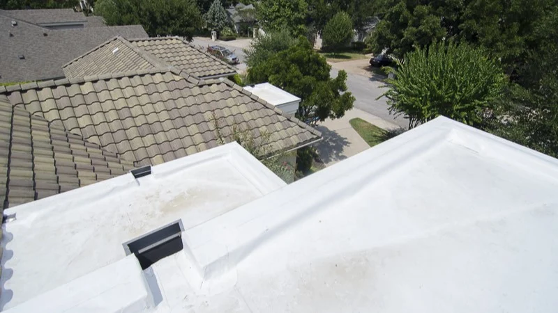 Amazing Residential Roof Replacements In Lakeway, TX | Freetail Roofing Close-up shot of white residential roof with a street view behind it