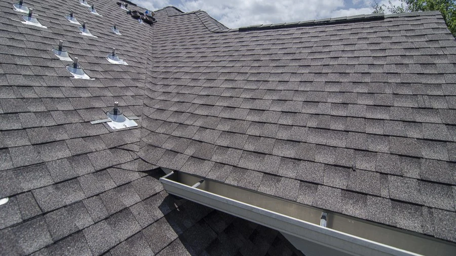 Best Residential Roof Replacement Company In Lakeway, TX | Freetail Roofing Close-up of newly installed brown asphalt shingle roof corner