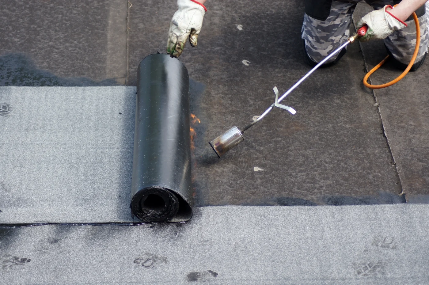 Commercial Roof Replacement | Burnet, TX | Freetail Roofing Image of a bitumen roof being installed on a commercial building in Burnet,TX | Freetail Roofing
