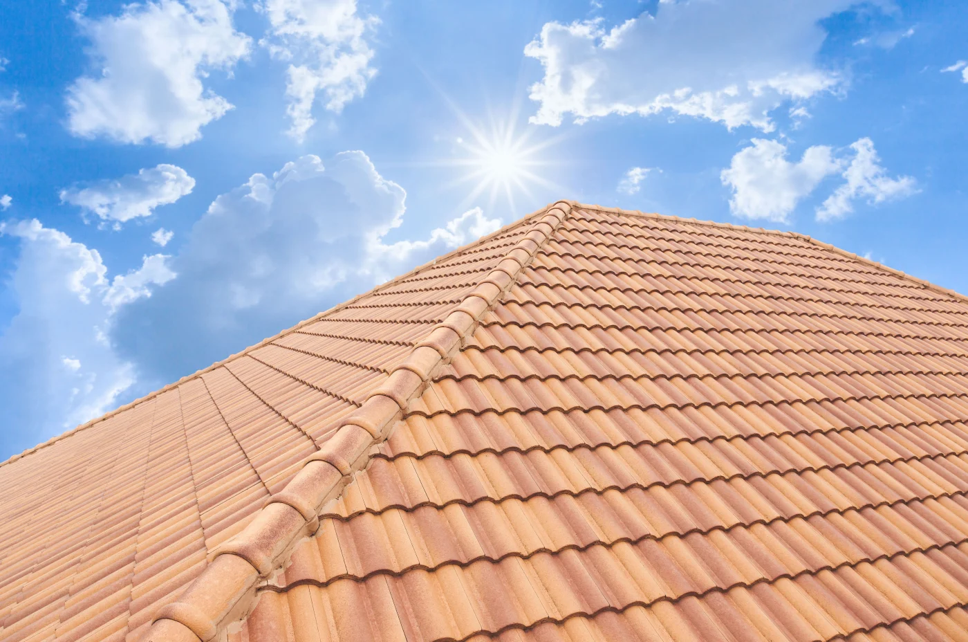 Aerial view of a brand new roof with orange concrete tiles.