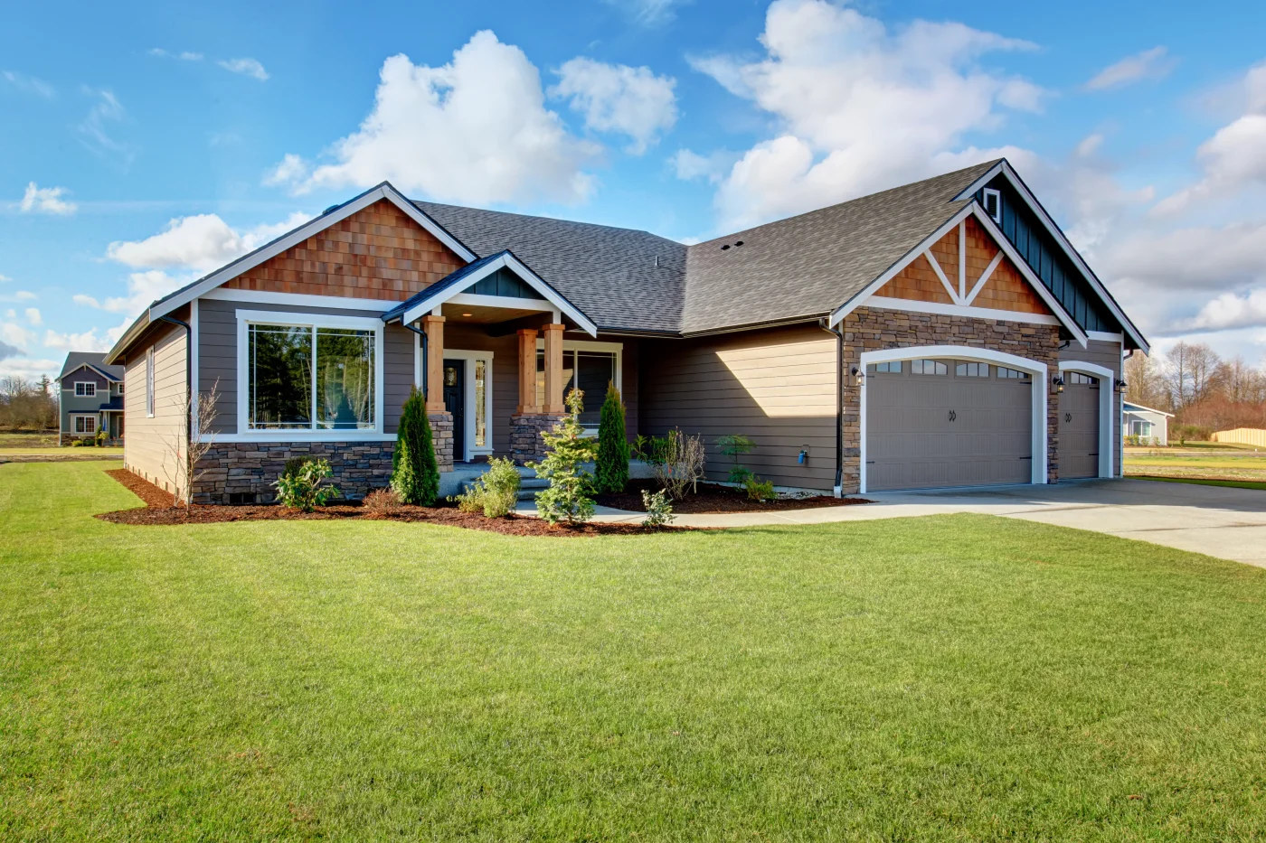 A stunning home with a garage, decorative siding, picture windows, and new asphalt shingles on its roof.