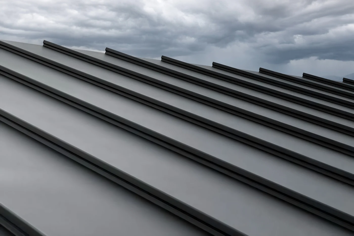 Close-up of galvanized steel metal roofing in front of an overcast sky.