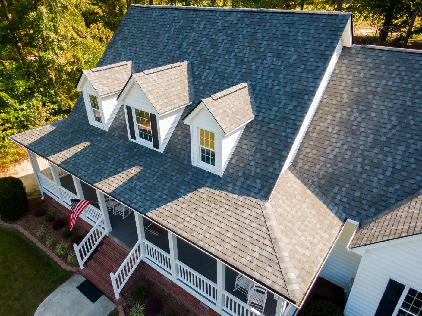 Premier Shingles Residential Roof Replacements | Cedar Park, TX | Freetail Roofing Aerial view of a beautiful home with new asphalt shingles on its roof.