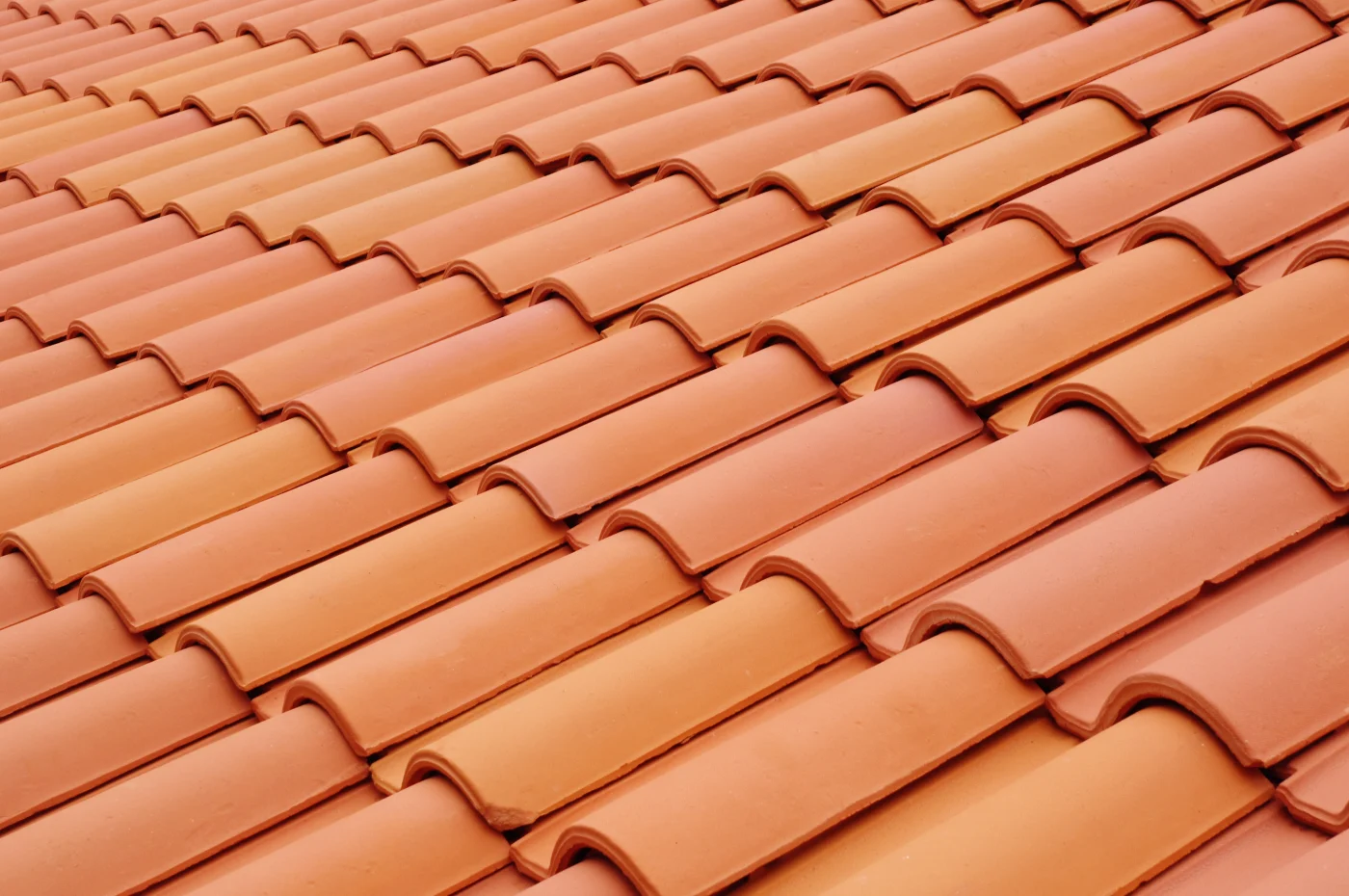 Close-up of new, orange ceramic tiles on a roof.